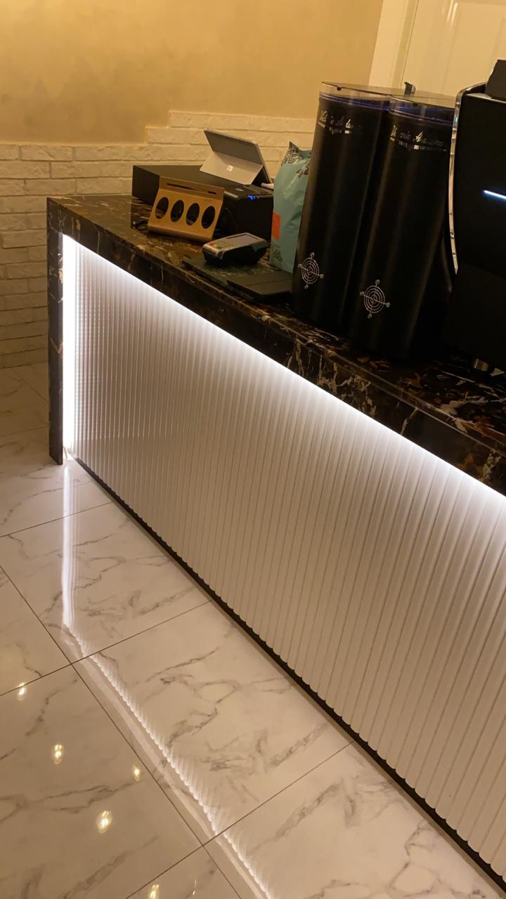 ARC Design café counter with marble top, LED lighting, and modern coffee equipment in Dubai