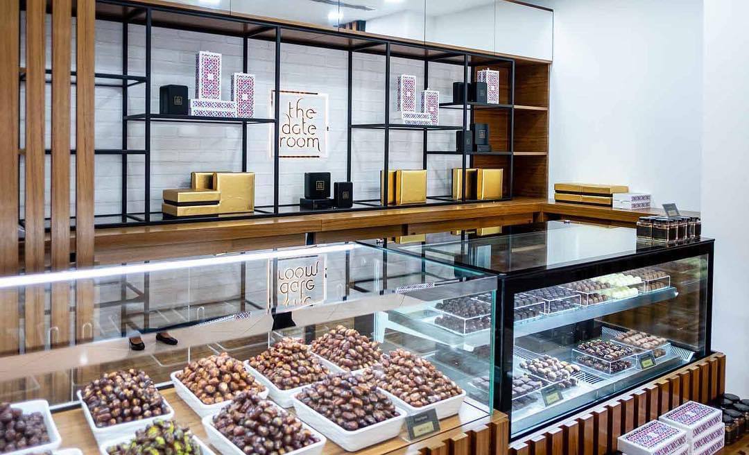 Date Room Galleria Mall Abu Dhabi | ARC Design glass display with wooden shelving