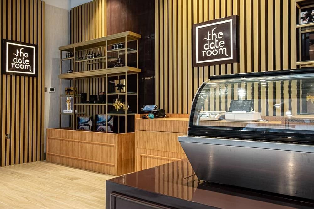 Date Room Galleria Mall Abu Dhabi | ARC Design wooden counter and glass display
